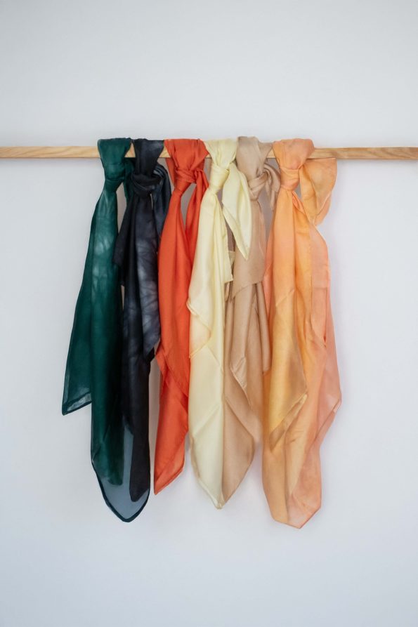 Hand-dyed silk tichel in soft yellow butter tone, draped and laid flat.