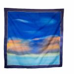 Hand-painted blue silk scarf with soft gradient tones, worn as a mitpachat for Jewish hair covering, from the "Fragment of Sky" collection.