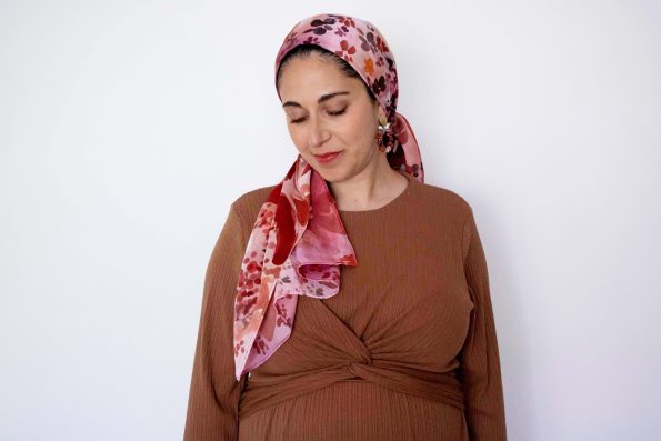 Hand-painted silk mitpachat with red, pink, and orange floral design – vibrant headscarf for Jewish women
