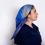 Hand-painted blue silk scarf with soft gradient tones, worn as a mitpachat for Jewish hair covering, from the "Fragment of Sky" collection.