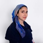 Hand-painted blue silk scarf with soft gradient tones, worn as a mitpachat for Jewish hair covering, from the "Fragment of Sky" collection.